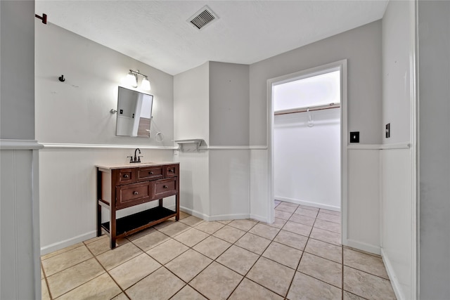 bathroom featuring a textured ceiling, tile patterned flooring, and vanity