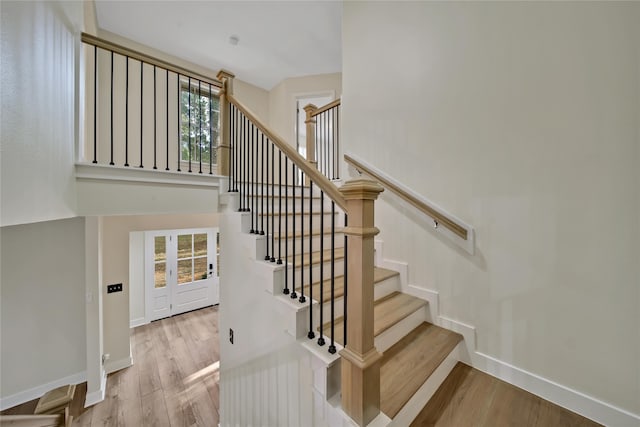 staircase with hardwood / wood-style flooring and plenty of natural light