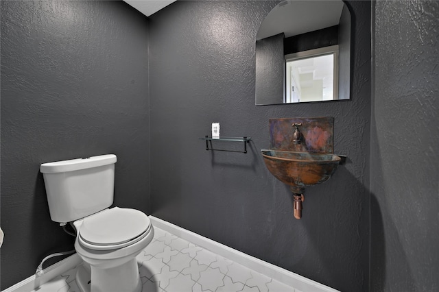 bathroom featuring sink and toilet