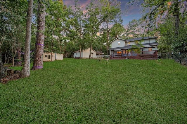 yard at dusk with a wooden deck