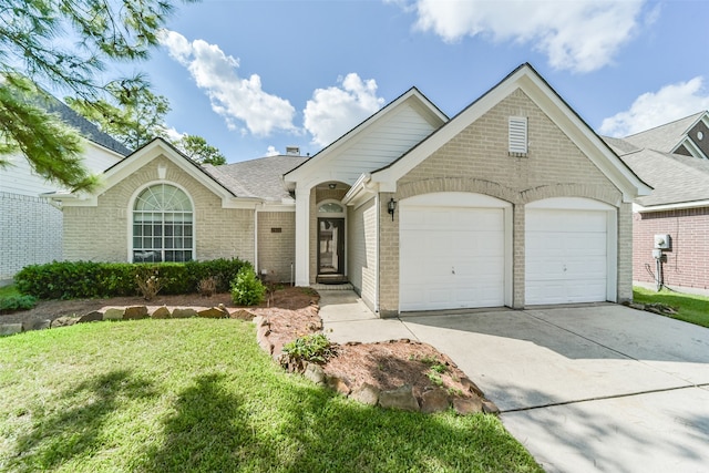 view of front of property featuring a front yard and a garage