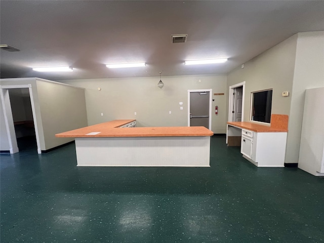 kitchen featuring white cabinets and a center island