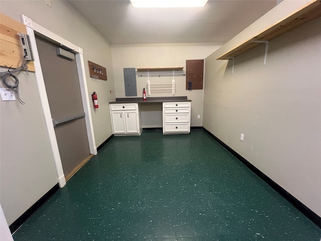 interior space with built in desk and electric panel