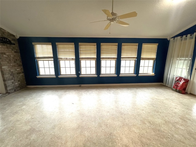 unfurnished living room featuring ceiling fan, a textured ceiling, and ornamental molding