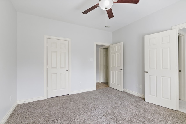 unfurnished bedroom featuring ceiling fan and light colored carpet