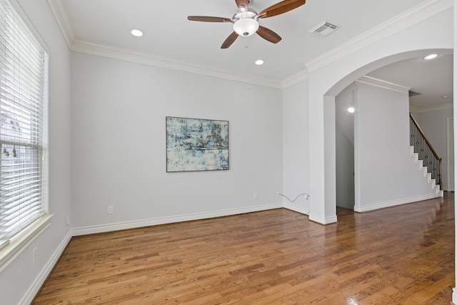 unfurnished room featuring wood-type flooring, ornamental molding, and ceiling fan