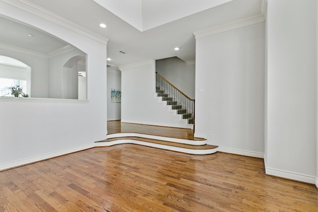 empty room featuring crown molding and hardwood / wood-style floors