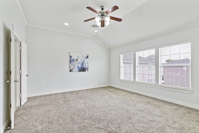 empty room with vaulted ceiling, ceiling fan, carpet floors, and crown molding