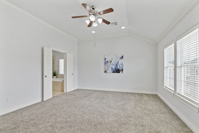 spare room featuring ceiling fan, ornamental molding, carpet flooring, and vaulted ceiling