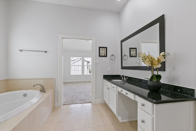 bathroom featuring tiled bath, vanity, and tile patterned floors