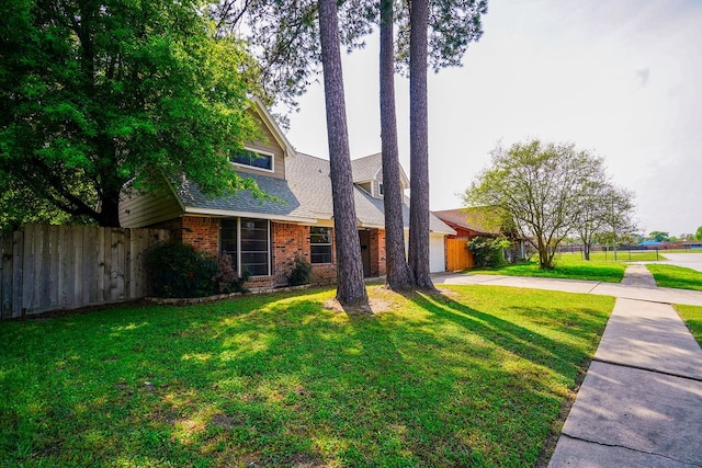 view of front facade with a garage and a front yard