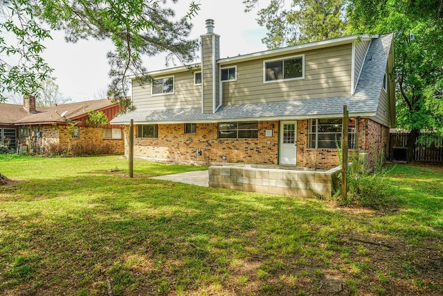 back of property featuring a lawn and a patio