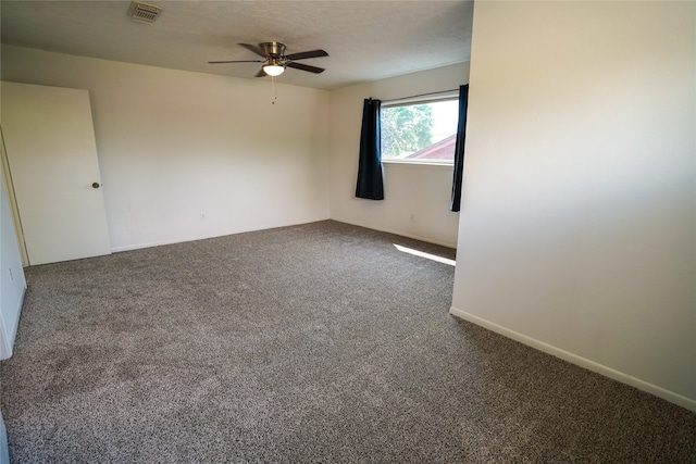 empty room featuring ceiling fan and carpet flooring