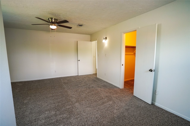 carpeted empty room featuring a textured ceiling and ceiling fan