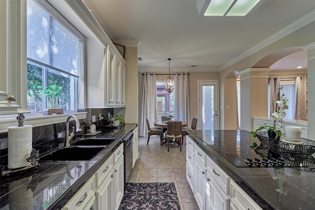 kitchen with plenty of natural light, sink, hanging light fixtures, and an inviting chandelier