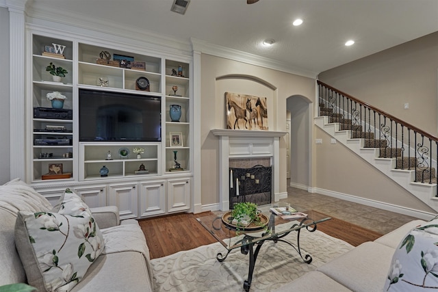 living room featuring wood-type flooring and ornamental molding