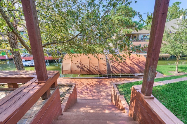 exterior space featuring a water view and a yard