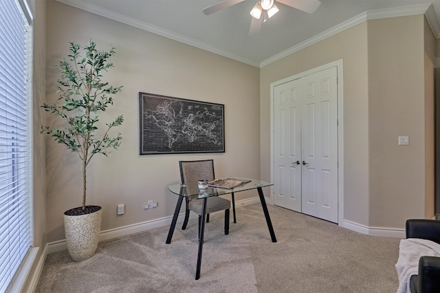 carpeted office space featuring crown molding and ceiling fan