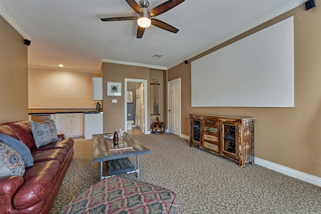 carpeted living room with a textured ceiling, ceiling fan, and crown molding