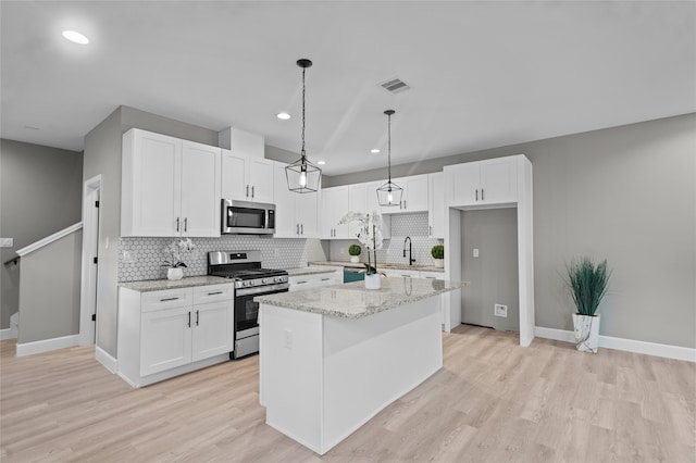 kitchen featuring white cabinetry, a kitchen island with sink, and stainless steel appliances