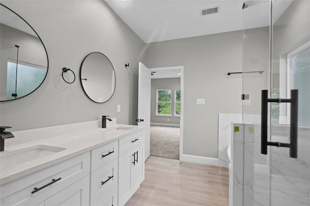 bathroom featuring vanity, an enclosed shower, and hardwood / wood-style flooring