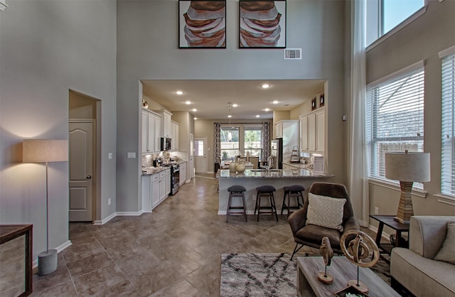 living room with a towering ceiling