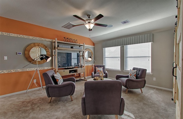 carpeted living room with ceiling fan and lofted ceiling