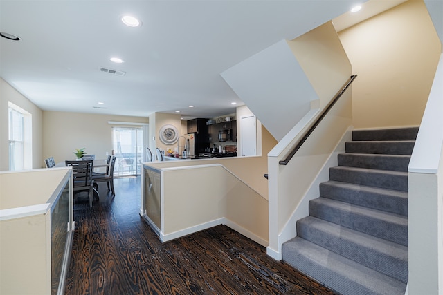 stairs with hardwood / wood-style floors