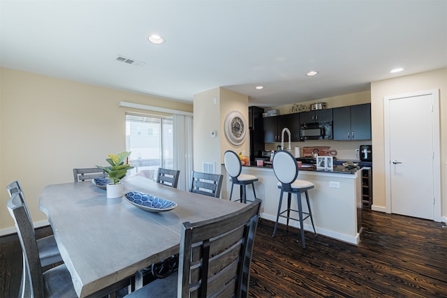 dining area featuring dark hardwood / wood-style floors