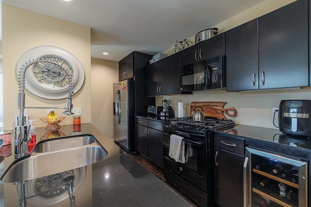 kitchen with black appliances and beverage cooler