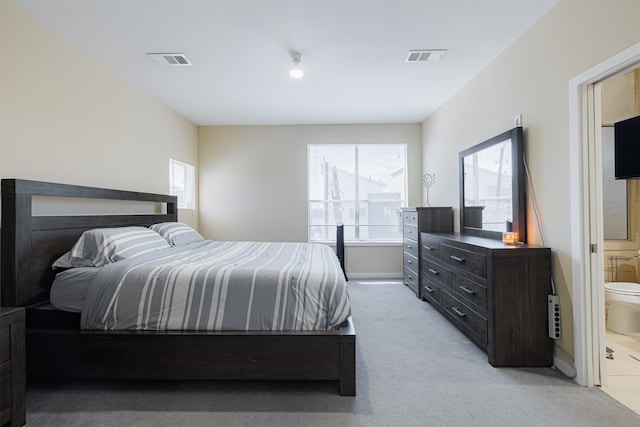 carpeted bedroom featuring ensuite bathroom