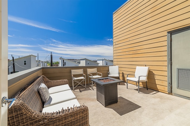 view of patio featuring an outdoor living space with a fire pit