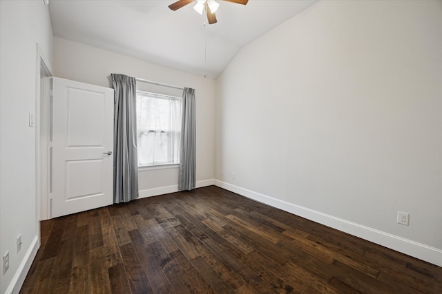 spare room featuring lofted ceiling, ceiling fan, and dark wood-type flooring