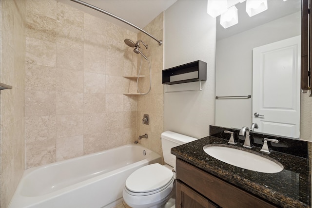 full bathroom with tiled shower / bath, vanity, and toilet