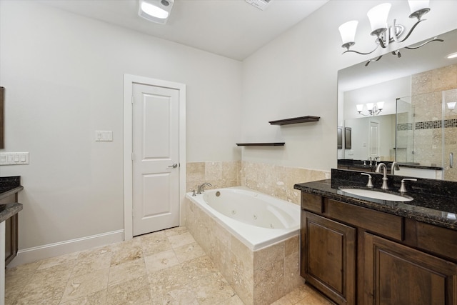 bathroom featuring vanity, a chandelier, and plus walk in shower