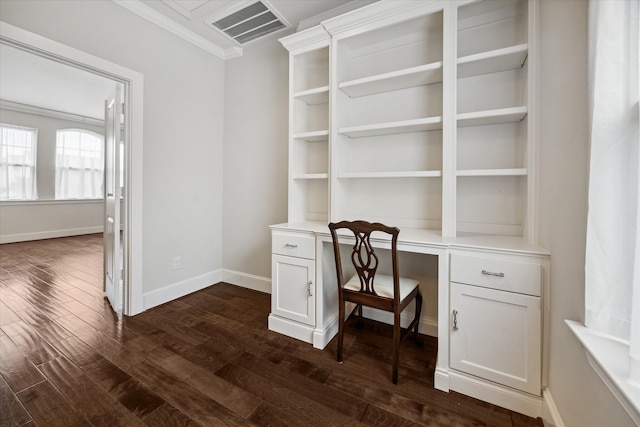 home office with built in desk, ornamental molding, and dark hardwood / wood-style flooring