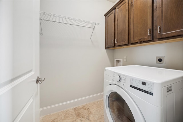 laundry room with cabinets and washer / dryer