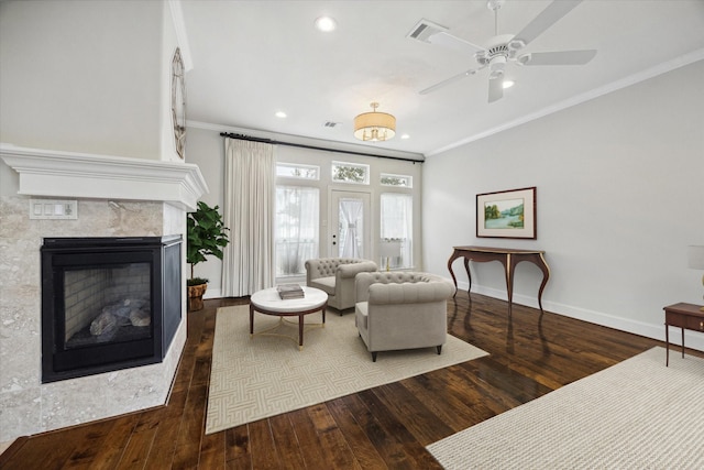 living room with wood-type flooring, ceiling fan, and crown molding