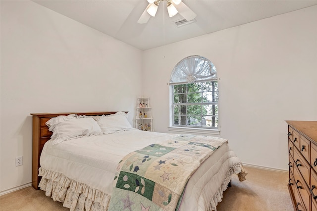 bedroom with light carpet, vaulted ceiling, and ceiling fan