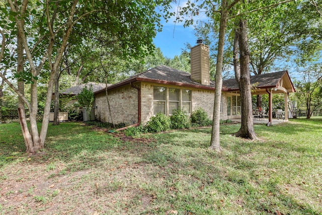 view of home's exterior featuring a patio area and a yard