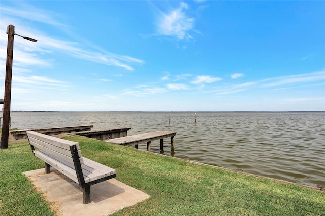 dock area featuring a yard and a water view