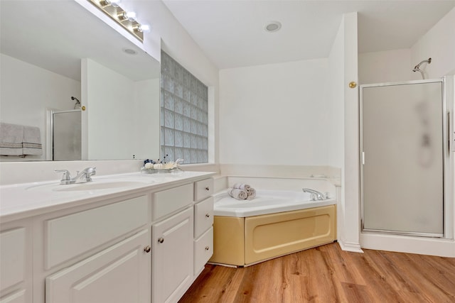 bathroom with vanity, separate shower and tub, and hardwood / wood-style flooring