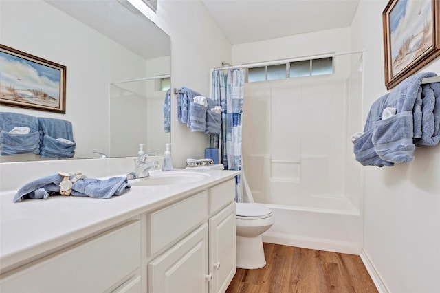 full bathroom with vanity, hardwood / wood-style floors, toilet, and shower / tub combo with curtain