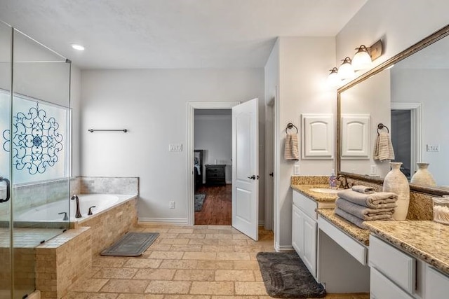 bathroom with vanity and separate shower and tub