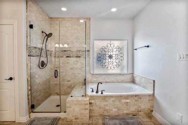 bathroom featuring shower with separate bathtub