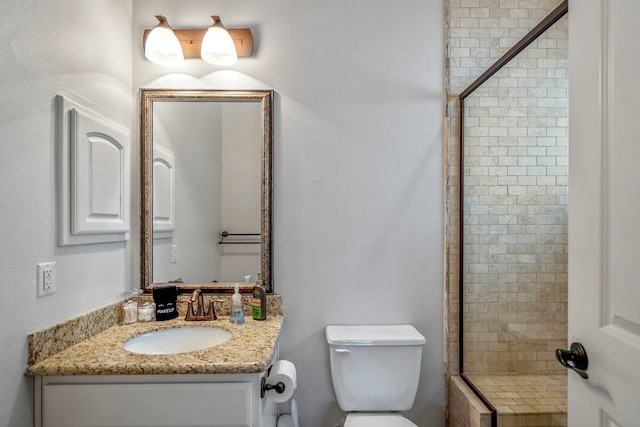 bathroom featuring vanity, toilet, and walk in shower