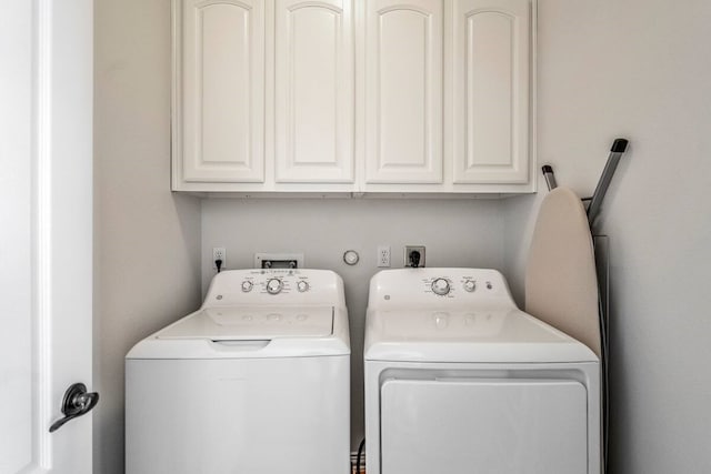 laundry room with washer and clothes dryer and cabinets