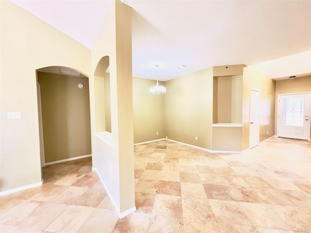 spare room featuring an inviting chandelier