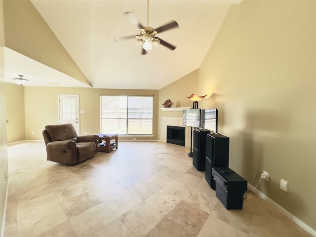 living room with ceiling fan, a fireplace, and vaulted ceiling