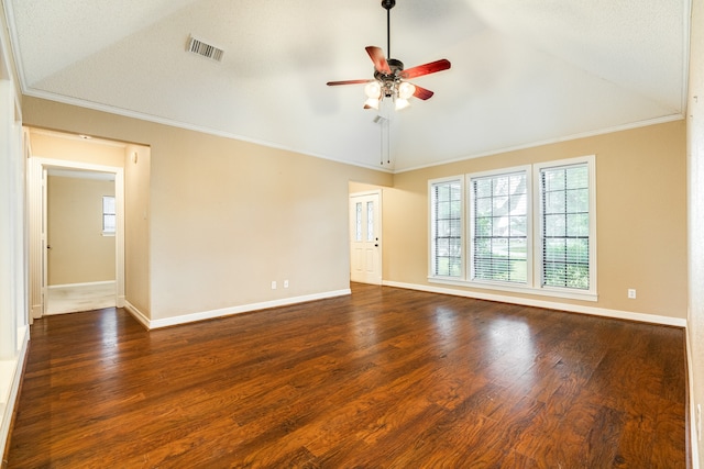 spare room featuring crown molding, vaulted ceiling, dark wood-type flooring, and ceiling fan